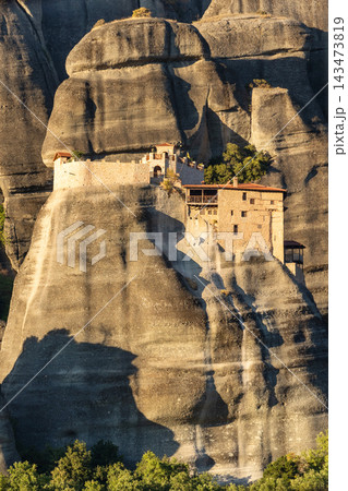 Meteora Greece Saint Nicholas Anapausas Monastery on massive rock cliff in warm sunlight Meteora Greece Saint Nicholas Anapausas Monastery on massive rock cliff in warm sunlight 143473819