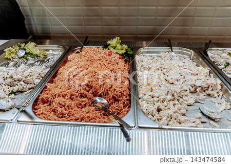 Buffet smorgasbord in hotel restaurant, various food garnish dishes on tray Buffet smorgasbord in hotel restaurant, various food garnish dishes on tray 143474584
