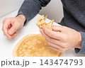 Man hand hold round pancake dessert, breakfast lunch brunch morning in cafe 143474793