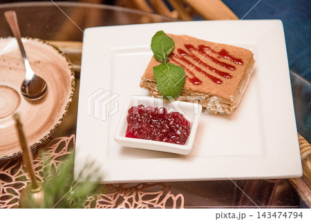 Tart honey cake Medovik sweet dessert, pastry on white plate on table restaurant Tart honey cake Medovik sweet dessert, pastry on white plate on table restaurant 143474794
