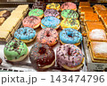 Donuts on counter of store, street food desserts are sold at festival food 143474796