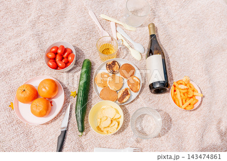 Countryside picnic summer weekend, wine, fruits and vegetables on rustic blanket Countryside picnic summer weekend, wine, fruits and vegetables on rustic blanket 143474861