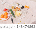 Countryside picnic summer weekend, wine, fruits and vegetables on rustic blanket 143474862