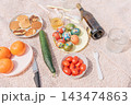 Easter picnic celebration with painted colored eggs, fruits, vegetables and wine 143474863