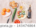 Easter picnic celebration with painted colored eggs, fruits, vegetables and wine 143474864