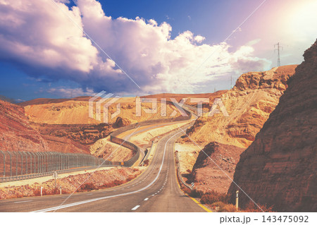 Driving a car on mountain Israel road. Desert landscape. Empty road. The road runs along the border of Israel with Egypt. View from the car of the mountain landscape on a sunny day. Israel 143475092