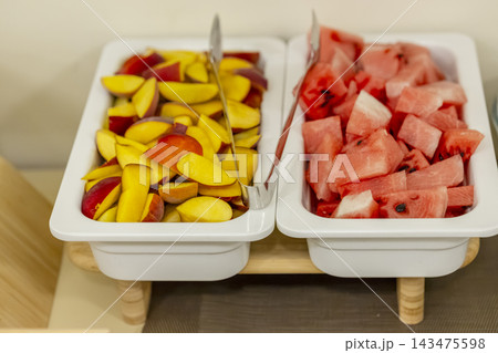 Fresh sliced watermelon and peaches serving buffet Fresh sliced watermelon and peaches serving buffet 143475598