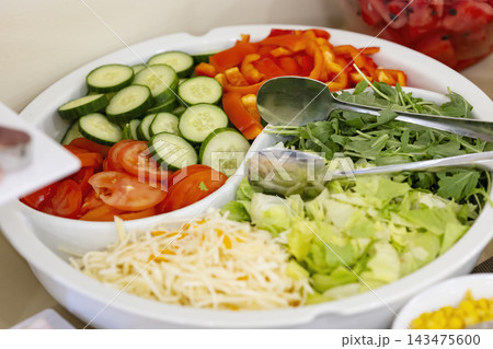 Fresh salad bar offering healthy vegetable choices 143475600