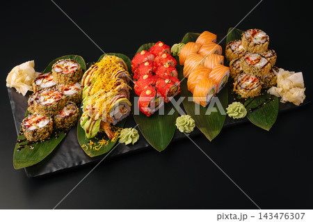 Sushi platter featuring various japanese rolls and garnishes Sushi platter featuring various japanese rolls and garnishes 143476307
