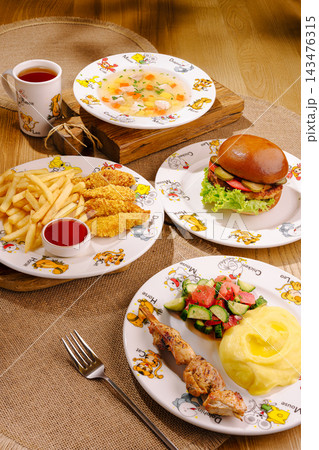 Kids menu variety serving burger nuggets soup kebab 143476315