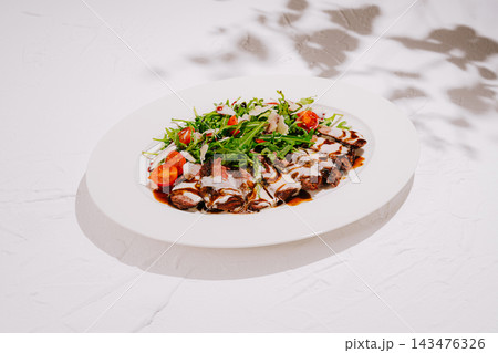 Beef steak tagliata with rocket salad and tomatoes Beef steak tagliata with rocket salad and tomatoes 143476326