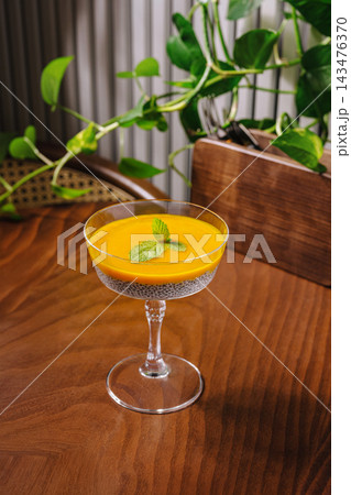 Chia seed pudding with mango puree and mint Chia seed pudding with mango puree and mint 143476370
