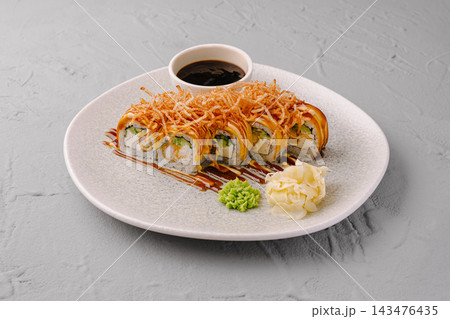 Sushi roll with crispy onion and eel sauce 143476435