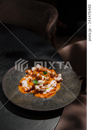 Ravioli pasta served with tomato cream sauce and basil Ravioli pasta served with tomato cream sauce and basil 143476488