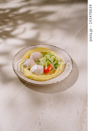 Mashed potato with chicken meatballs, cucumber, and tomato salad Mashed potato with chicken meatballs, cucumber, and tomato salad 143476634