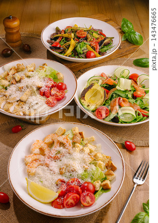Various healthy salads and appetizers with fresh ingredients 143476665