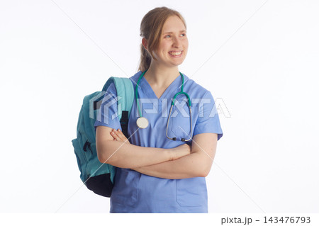 Smiling Nursing Student Looking Away in Blue Scrubs Smiling Nursing Student Looking Away in Blue Scrubs 143476793