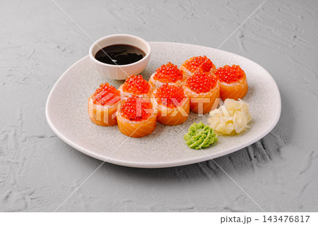 Salmon sushi rolls with red caviar serving Salmon sushi rolls with red caviar serving 143476817