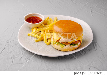 Chicken burger meal with french fries and chili sauce 143476980