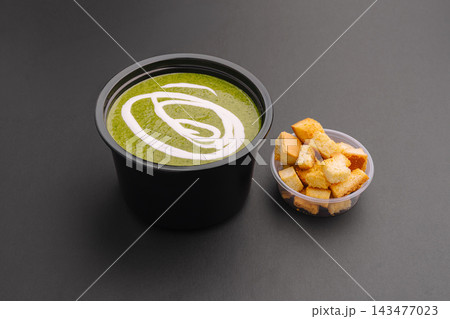 Spinach cream soup and croutons in takeaway containers Spinach cream soup and croutons in takeaway containers 143477023