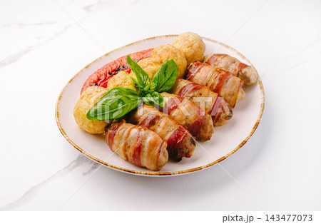 Bacon wrapped chicken bites with potato croquettes Bacon wrapped chicken bites with potato croquettes 143477073