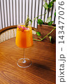 Refreshing orange cocktail with rosemary and dried raspberries 143477076