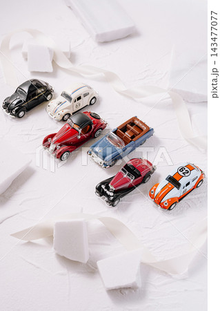Collecting vintage miniature classic cars on white background Collecting vintage miniature classic cars on white background 143477077