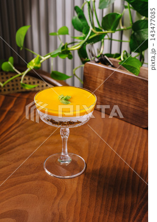 Mango parfait dessert with granola and mint leaf 143477085