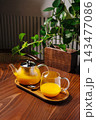 Sea buckthorn tea serving on wooden tray at home 143477086