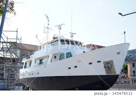 Large White Luxury Motor Yacht Under Maintenance at Italian Shipyard Large White Luxury Motor Yacht Under Maintenance at Italian Shipyard 143479512