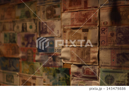 Collage of diverse international banknotes pinned to a wall. Collage of diverse international banknotes pinned to a wall. 143479886