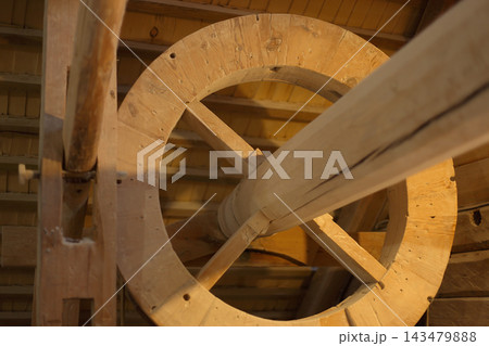 Low angle close-up of a massive traditional wooden mechanism. Low angle close-up of a massive traditional wooden mechanism. 143479888