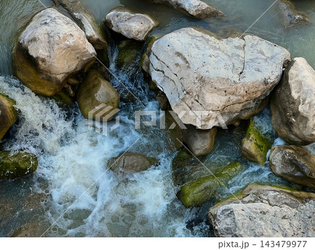 Small Cascading Waterfall Over Large Boulders in a Sunny Forest. Small Cascading Waterfall Over Large Boulders in a Sunny Forest. 143479977