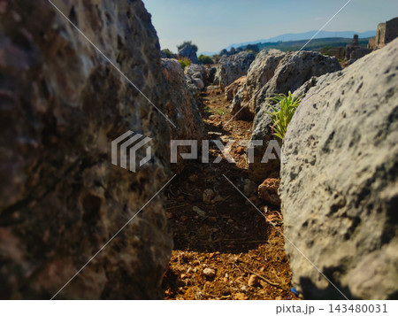 Ancient archaeological stone ruins and burial site in a scenic mountain landscape. Ancient archaeological stone ruins and burial site in a scenic mountain landscape. 143480031