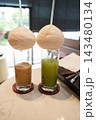 Iced coffee and matcha served in coconuts 143480134
