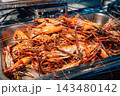 Large pile of cooked orange giant river prawns with long claws in stainless steel serving tray, seafood buffet presentation 143480142