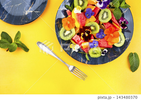 Fresh Summer Fruit Salad with Edible Flowers and Tropical F Fresh Summer Fruit Salad with Edible Flowers and Tropical F 143480370
