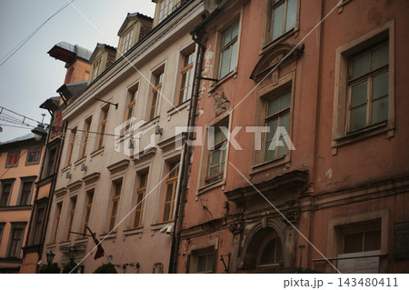 Atmospheric perspective of a historical old town street featuring classical facades with arched. 143480411