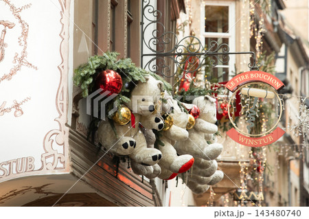 Strasbourg, France - December 24, 2025: Christmas teddy bear decorations on the famous Le Tire-Bouchon restaurant facade in Alsace 143480740
