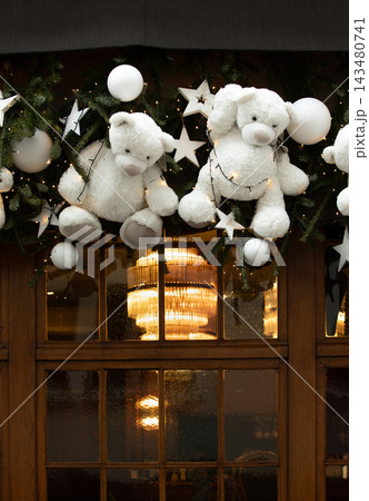 Christmas in Strasbourg, Alsace, France. Cute white teddy bears with Christmas ornaments, evergreen branches and glowing lights 143480741