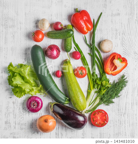 Fresh assortment of colorful vegetables arranged on a rustic white background Fresh assortment of colorful vegetables arranged on a rustic white background 143481010