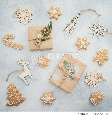 Rustic Christmas cookies, snowflakes and gifts arranged on soft neutral background. 143481048