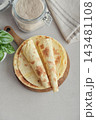Stack of lavash or chapati flatbreads on a wooden cutting board 143481108