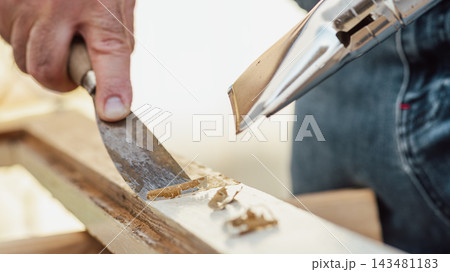 Carpenter at work, restoring an old wooden window. Carpentry. Carpenter at work, restoring an old wooden window. Carpentry. 143481183