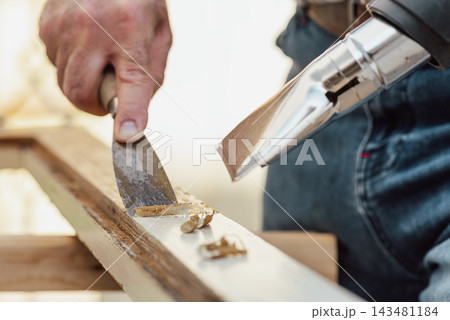 Carpenter at work, restoring an old wooden window. Carpentry. Carpenter at work, restoring an old wooden window. Carpentry. 143481184