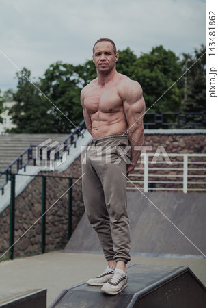 A CrossFit man poses for the camera on a sports A CrossFit man poses for the camera on a sports 143481862