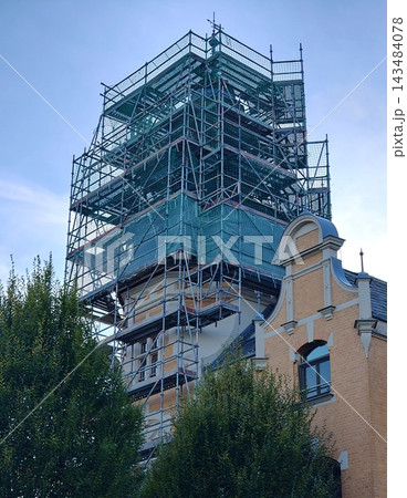 Scaffolding on the tower of an old building during restoration. 143484078