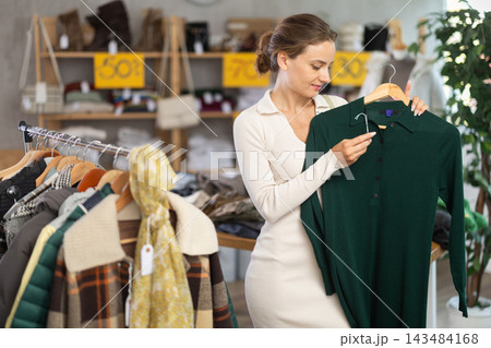 During November sales, woman choose and buy warm knitted dress During November sales, woman choose and buy warm knitted dress 143484168