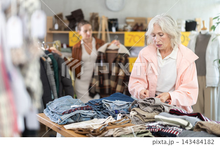 Elderly woman choosing trousers in clothing store 143484182