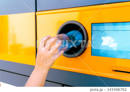 Plastic bottle inserted into reverse vending machine. 143486762